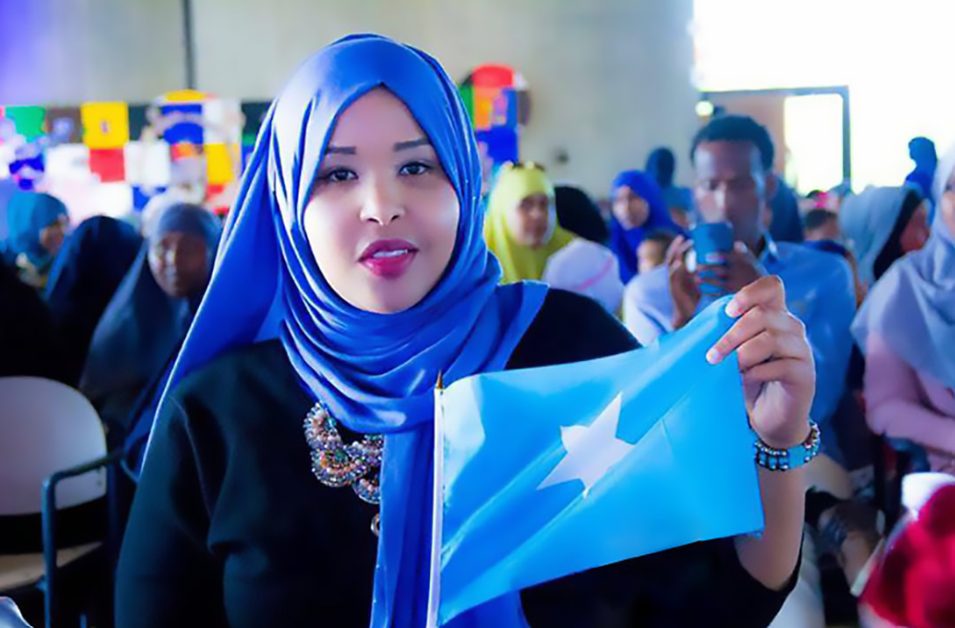 Woman holding the flag of Somalia.