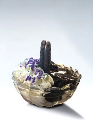 Johnson's Real Ice Cream's Eclipse Sundae has vanilla ice cream, marshmallow topping and whipped cream on one side, and hot fudge and Oreo pieces on the other.