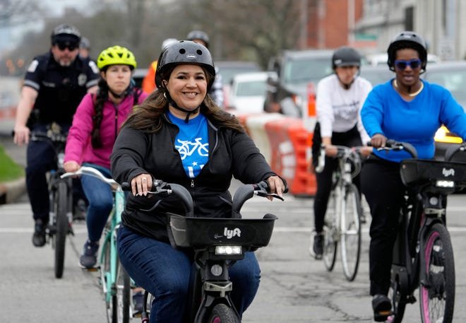Columbus City Councilmember Lourdes Barroso de Padilla rides with a group of cyclists Wednesday afternoon testing a quick-build, two-way separated path the city Department of Public Service created on East Broad Street between Franklin Park West and the entrance to Wolfe Park.