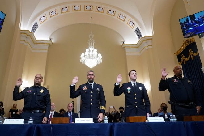 From left to right, U.S. Capitol Police Sgt. Aquilino Gonell, DC Metropolitan Police Department Officer Michael Fanone, DC Metropolitan Police Department Officer Daniel Hodges and U.S. Capitol Police Private First Class Harry Dunn, are sworn in before members of the Select Committee, as they investigate the January 6, 2021, attack on the U.S. Capitol, during their first hearing on Capitol Hill in Washington, DC, on July 27, 2021.