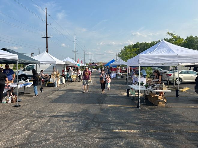 Customers stroll among the vendor tents at the Hilliard Farm Market, which opens May 21.