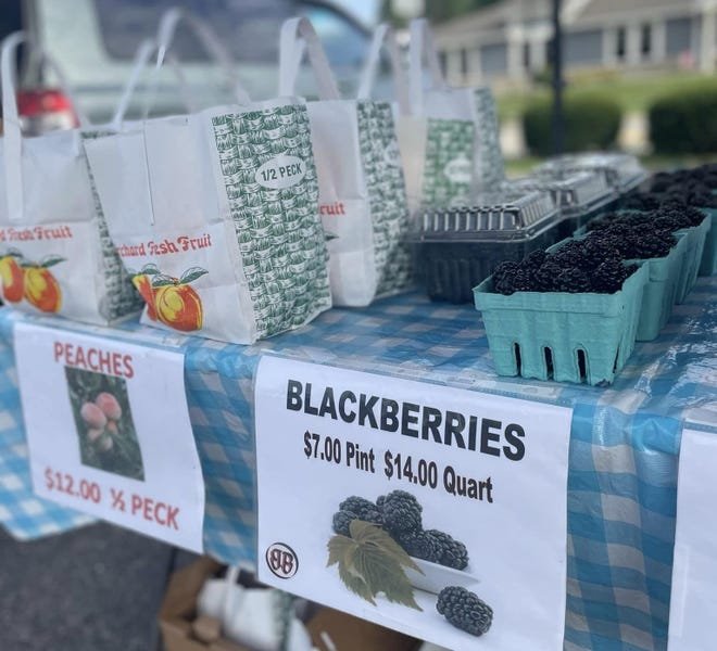 Farmers markets are ripe with fresh fruit, like this display at the Powell Chamber Farmers Market, where you can pick a peck of peaches or bag a bunch of blackberries. The Powell market opens May 25.