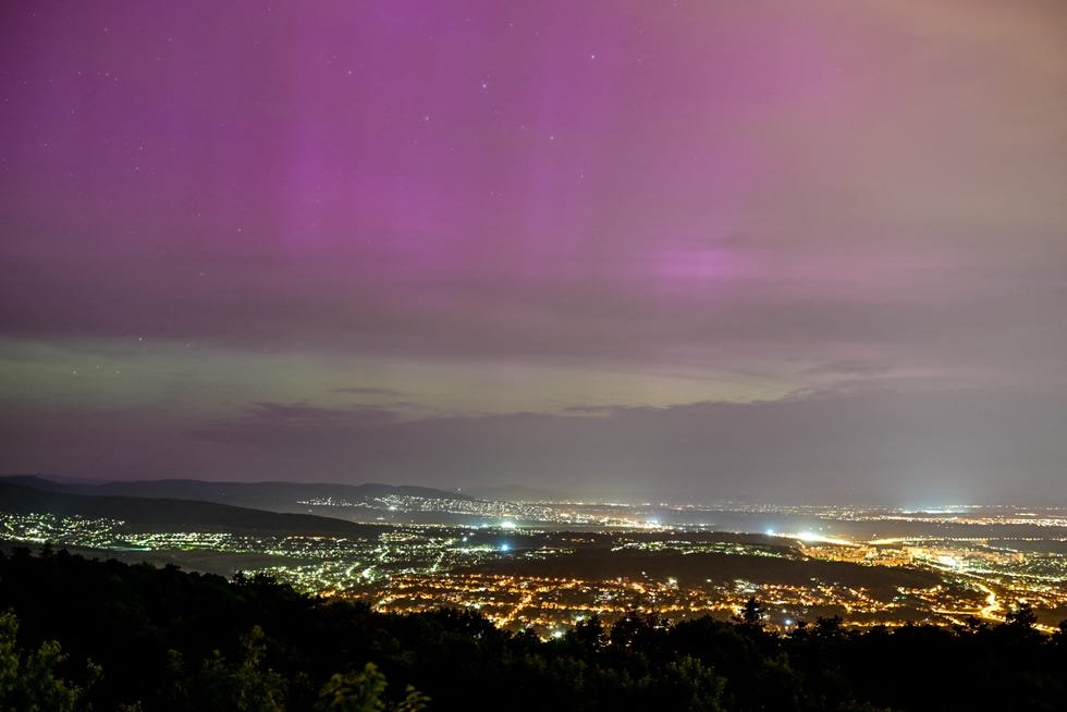 An aurora borealis is seen above Urom and Pilisborosjeno, from Harmashatar Hill in Budapest, Hungary, May 11, 2024. REUTERS/Marton Monus