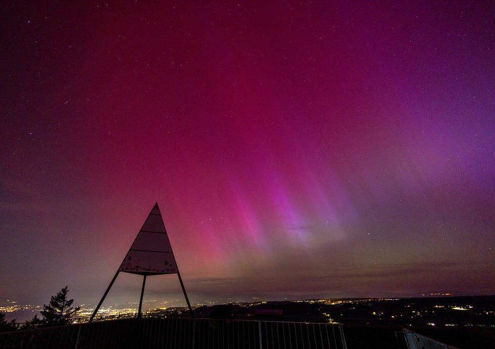 An aurora borealis is seen above Lausanne and the Jura from the Tour de Gourze in Riex, Switzerland, May 11, 2024. REUTERS/Denis Balibouse